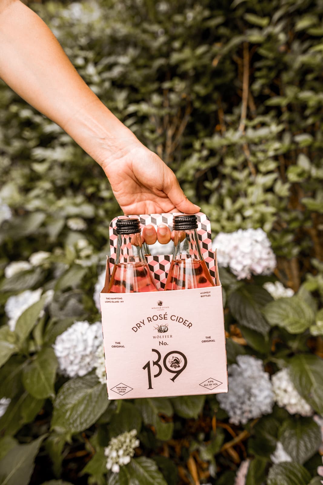 Charmed by Camille blogger holding drinks 